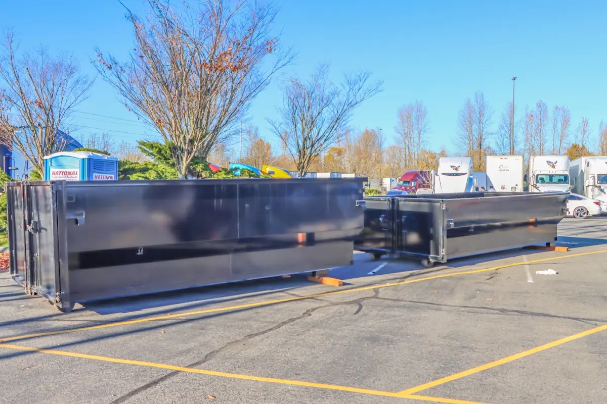 Professional dumpster rental service with roll-off container on residential driveway in Pleasant View